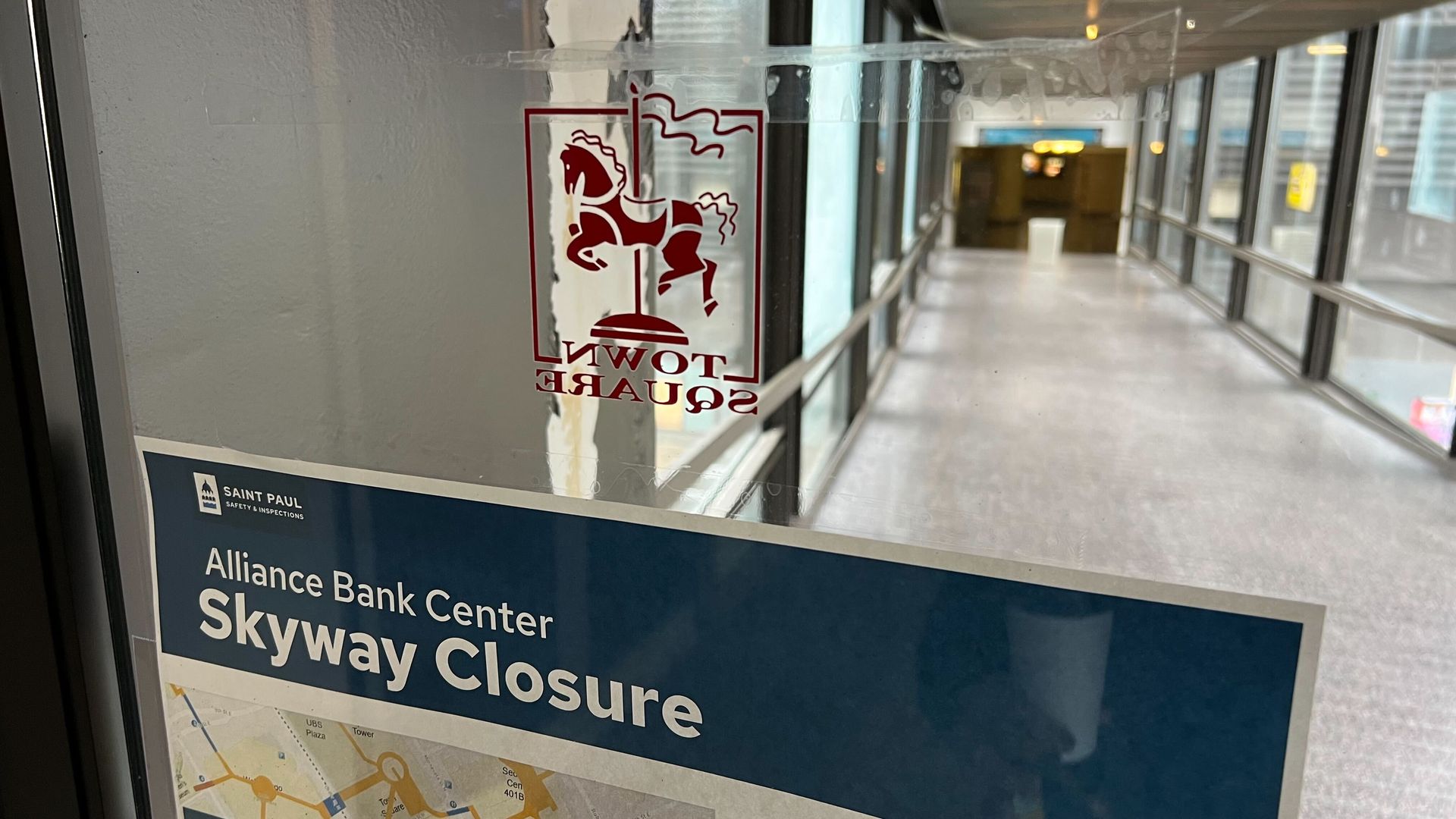 a sign that says Alliance Bank Cneter Skyway Closure on a glass door