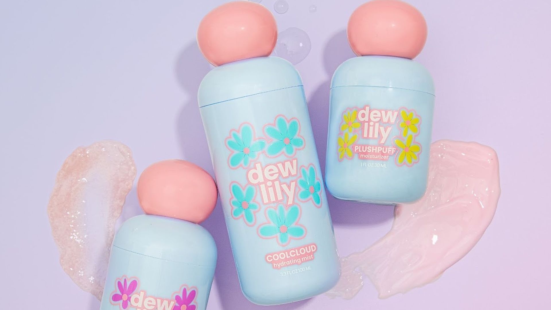 Three pastel blue Dew Lily skincare bottles with pink caps on a lavender background, labeled Flutterfluff, Coolcloud, and Plushpuff, with product textures beside them.