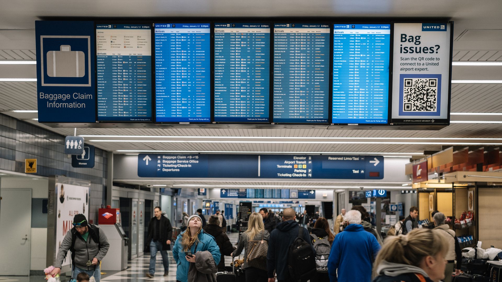 Photo of screens with flight arrivals and departures at an airport