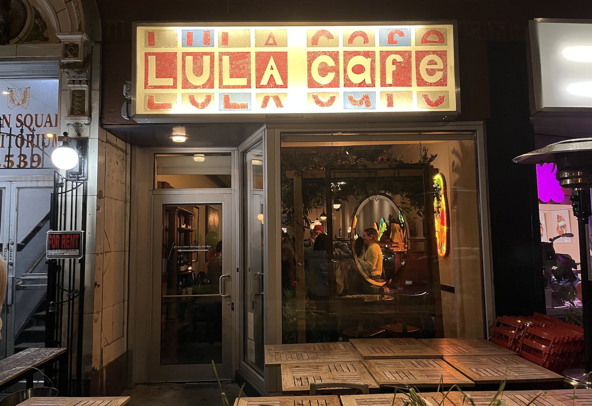 From of restaurant with brightly colored sign reading Lula Cafe.