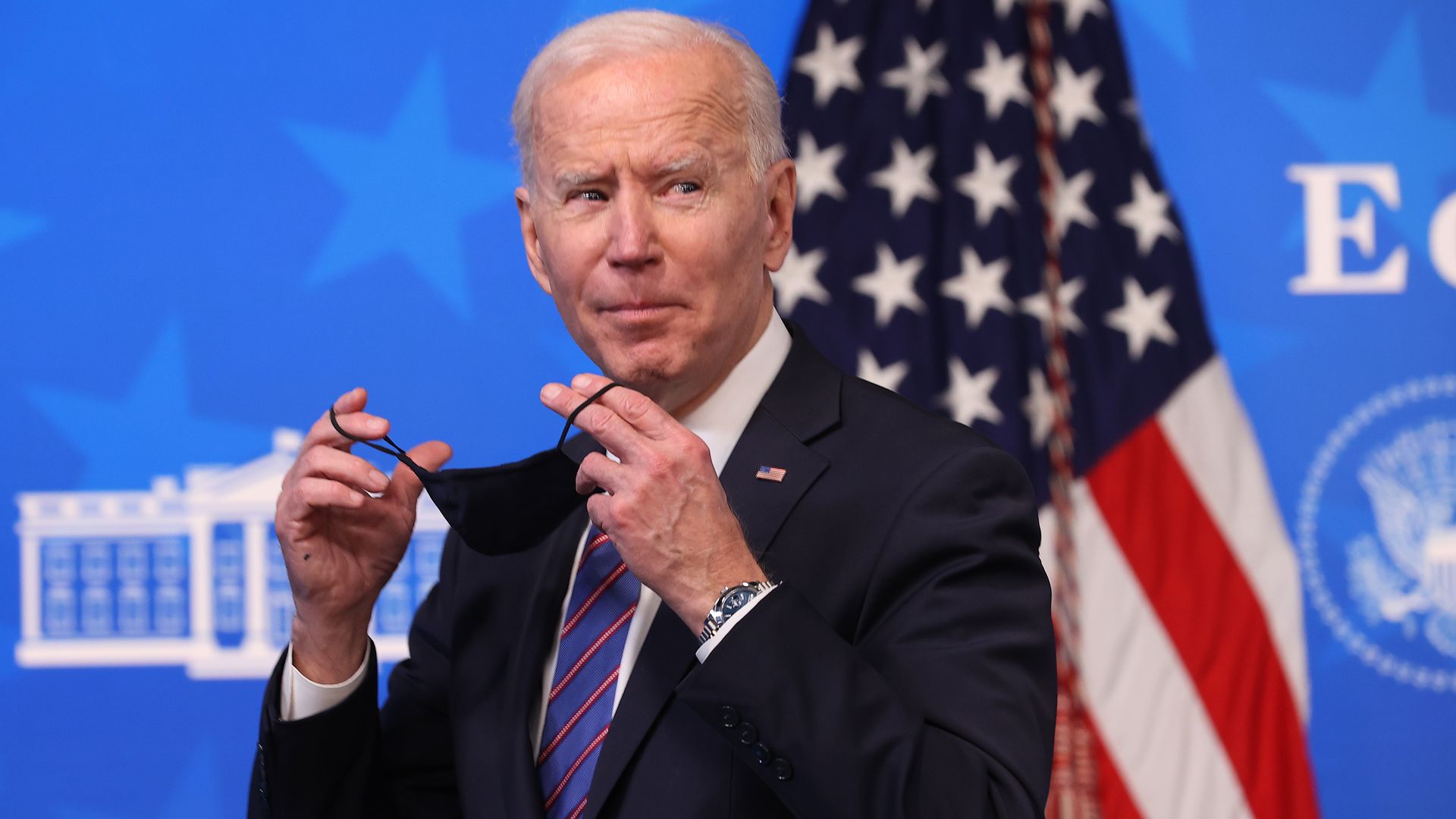 Joe Biden putting on a mask.