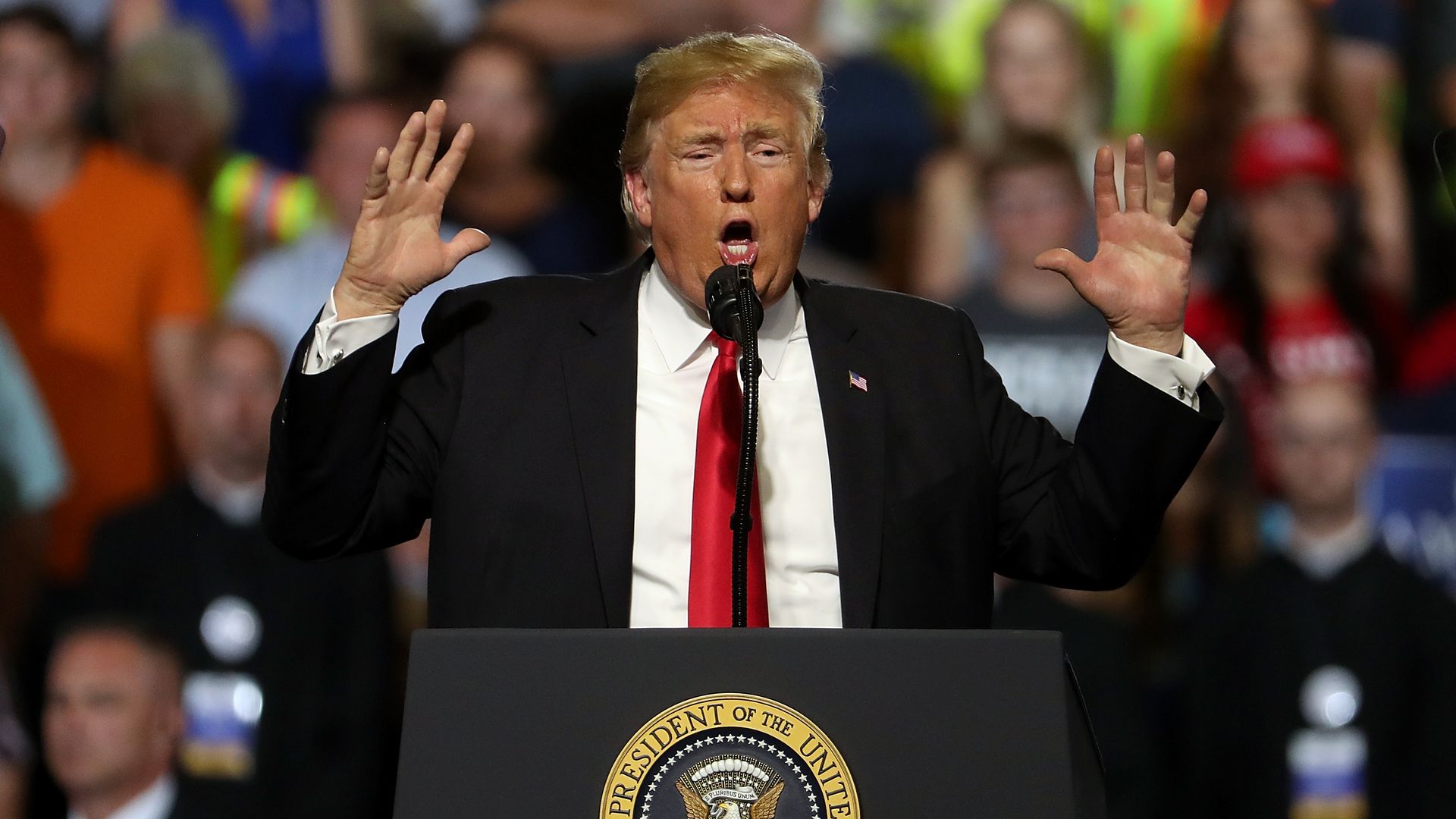 Donald Trump throws his hands up while speaking at a rally in Montana