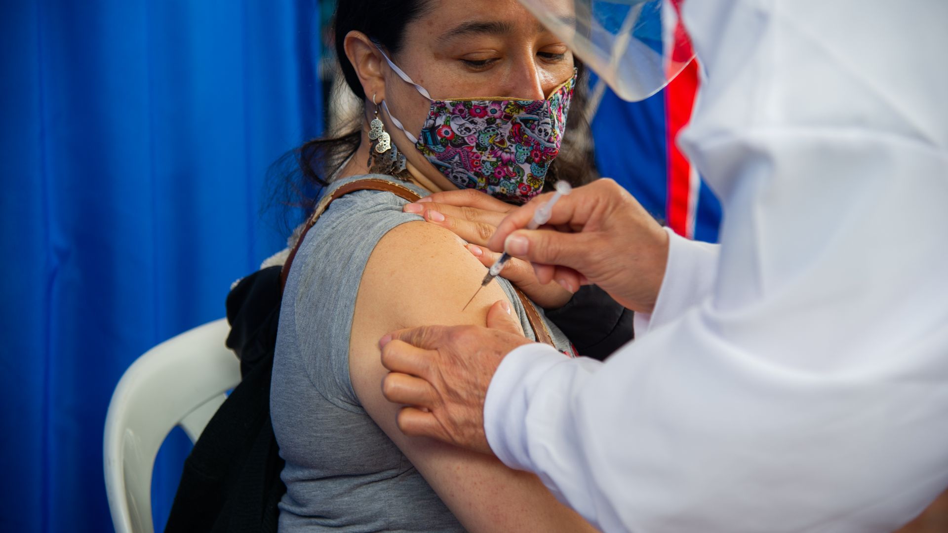 A mother gets vaccinated against COVID-19