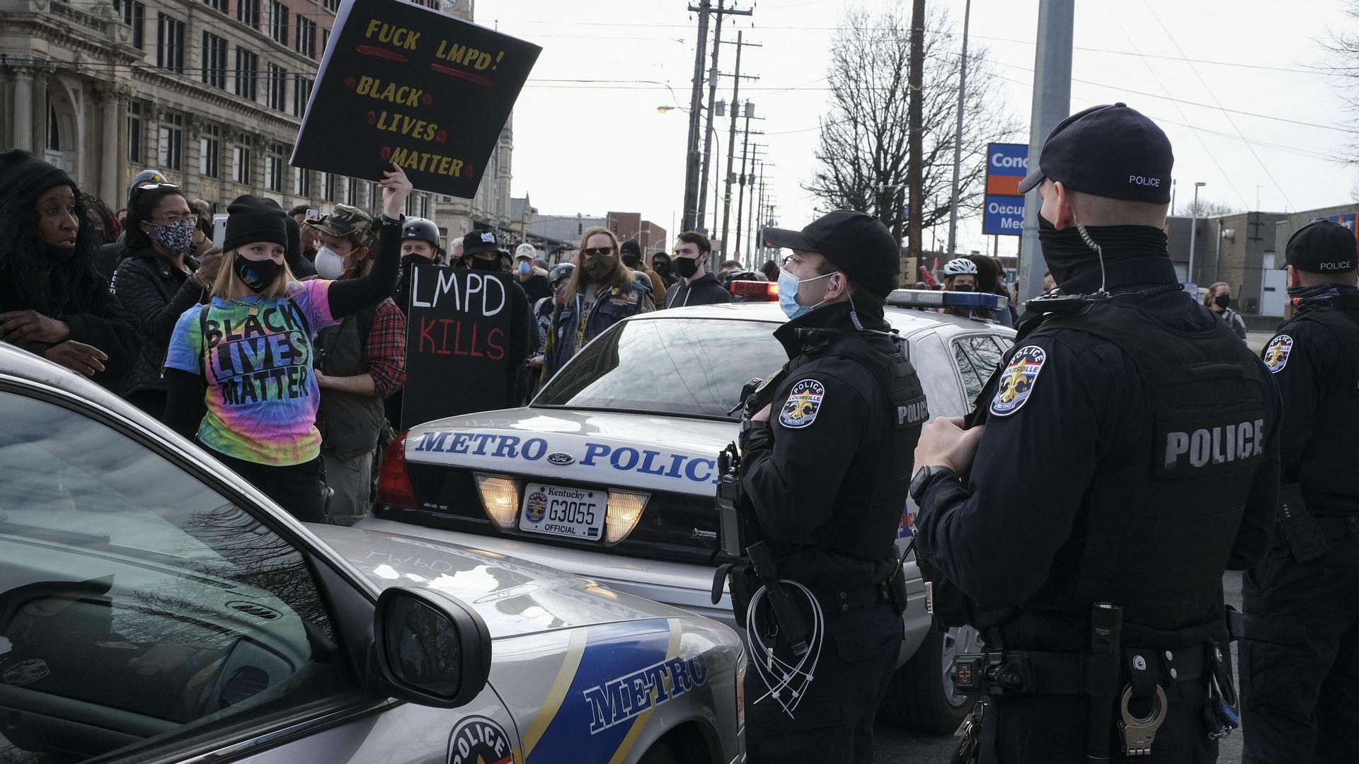 Louisville Metro Police Department officers and protesters in Louisville in March 2021.