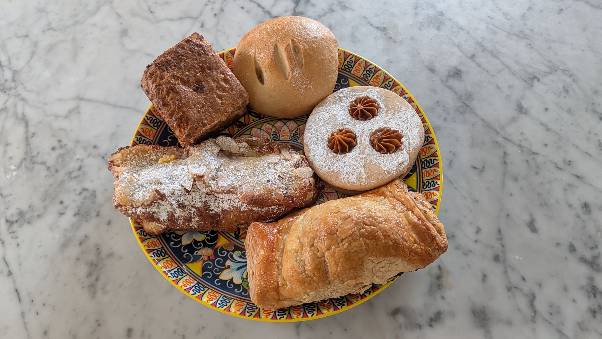 A plate full of baked goods like pastries and cookies.