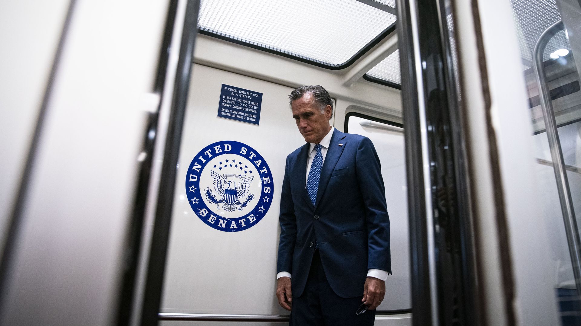 Sen. Mitt Romney is seen standing in a Senate subway car during a break in bipartisan infrastructure deal on Tuesday.