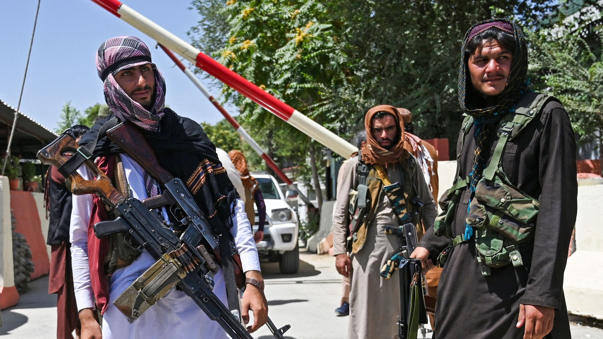  Taliban fighters stand guard along a roadside near the Zanbaq Square in Kabul on August 16, 2021