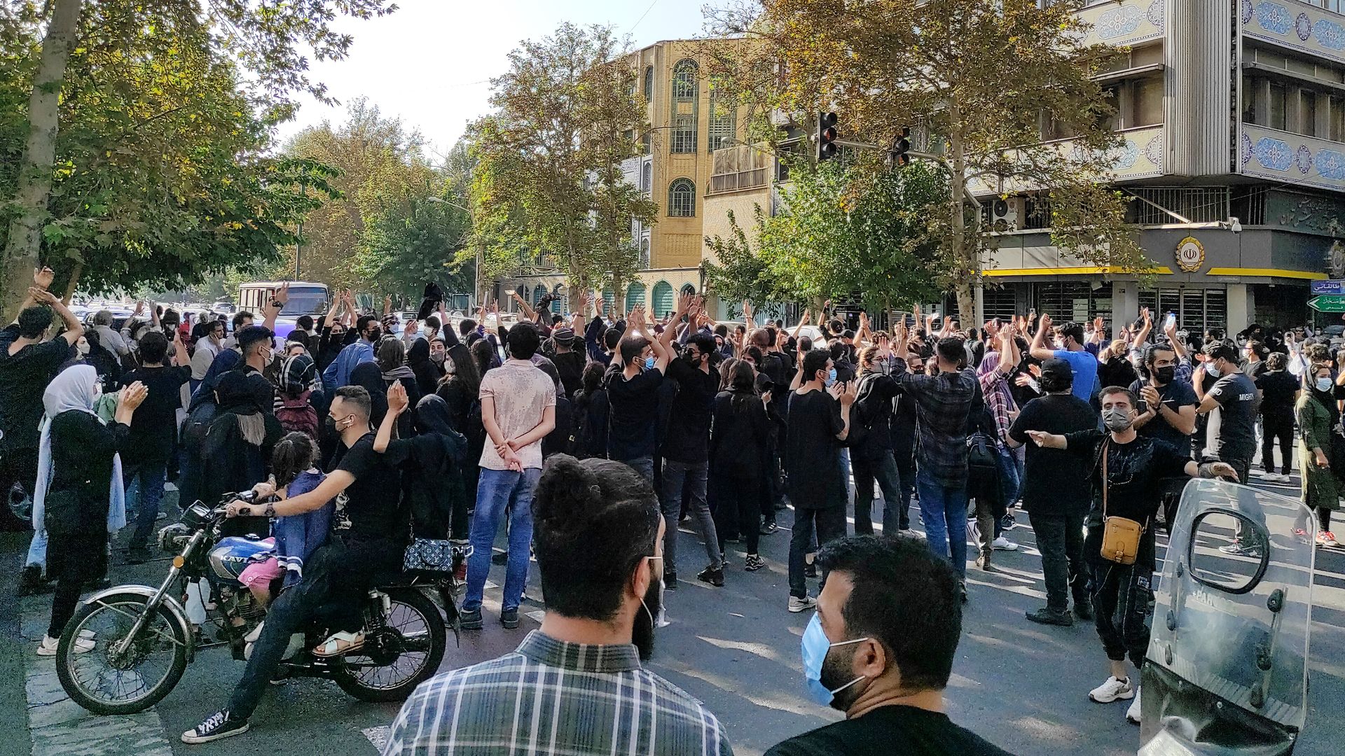 Iranian protesters march down a street on October 1, 2022 in Tehran, Iran.