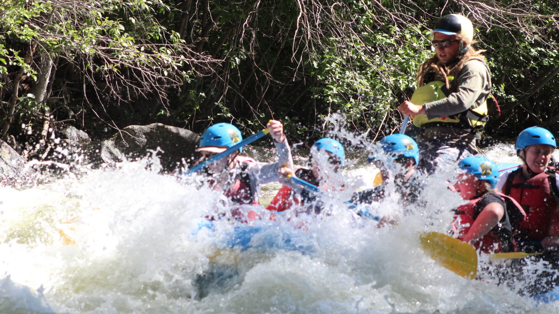 A rapid on the Taylor River swamps John, lower center, as guide Drea Hanks, upper center, steers the raft July 15. Photo courtesy of Whitewater Photography