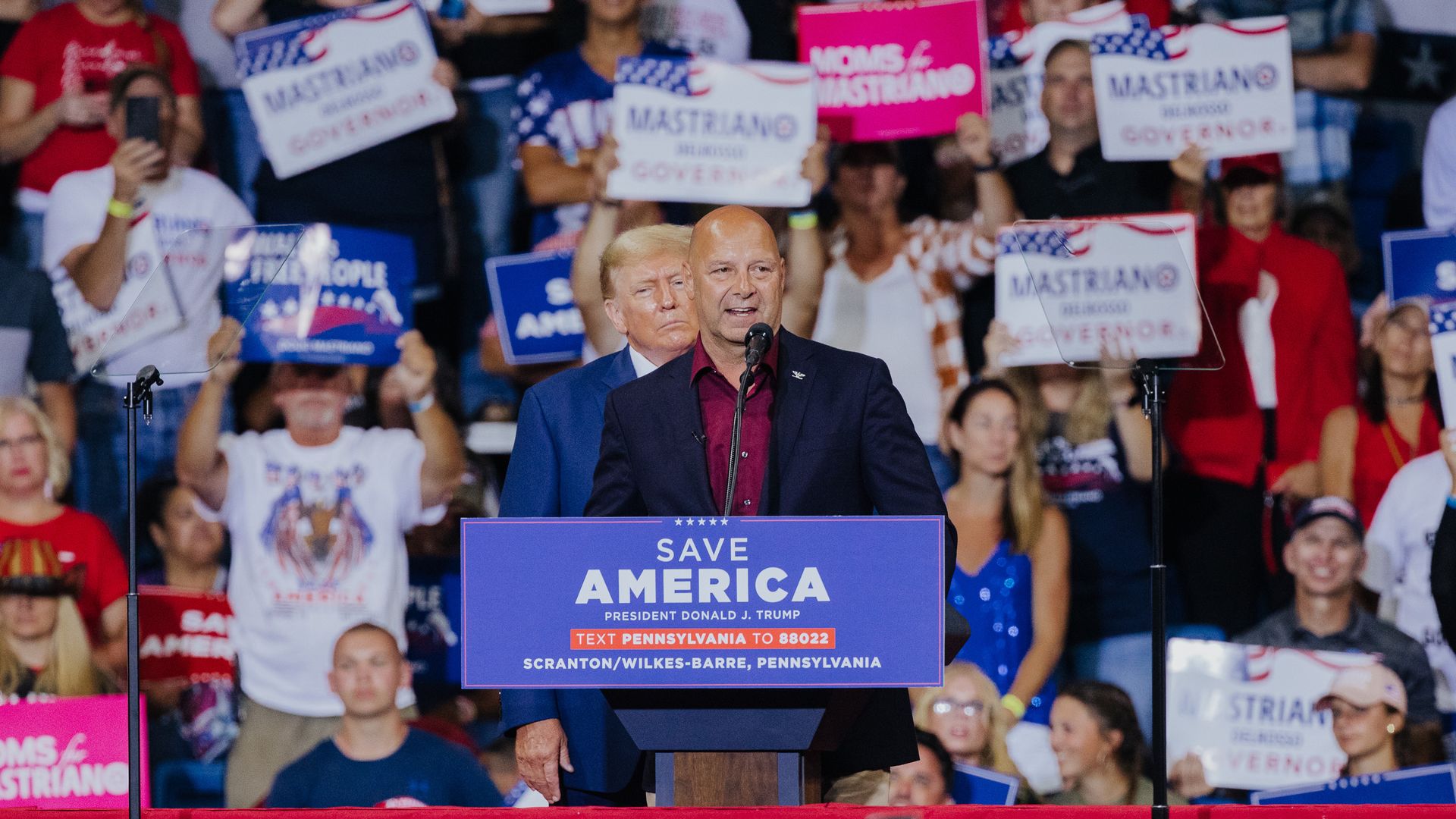 Pennsylvania GOP gubernatorial nominee Doug Mastriano speaks at a rally with former President Donald Trump just behind him.