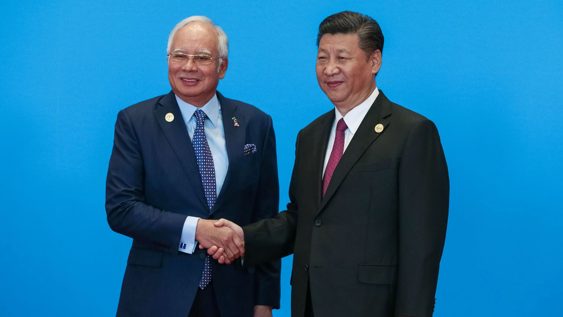 China's President Xi Jinping shakes hands with Malaysia's Prime Minister Najib Razak during the welcome ceremony for the Belt and Road Forum