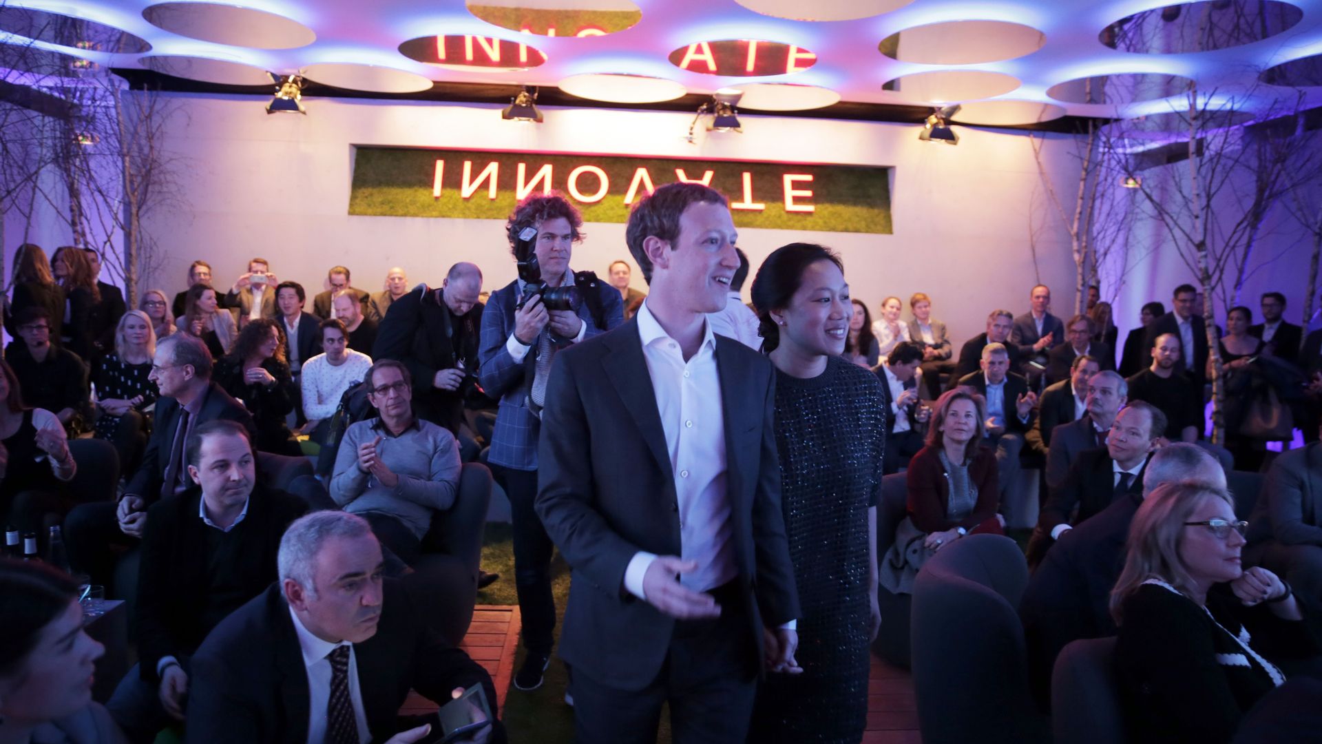 Mark Zuckerberg walks with his wife, Priscilla Chan