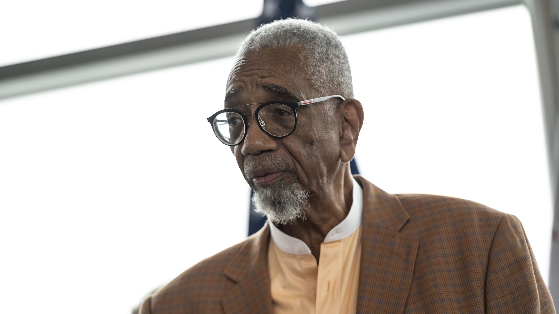 Photo of a man talking to reporters. 