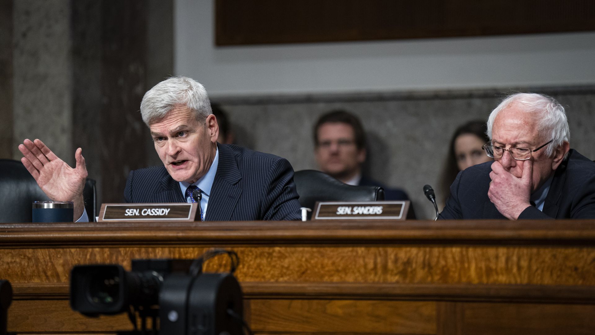 Senator Bill Cassidy talks as Senator Bernie Sanders listens at a Senate hearing