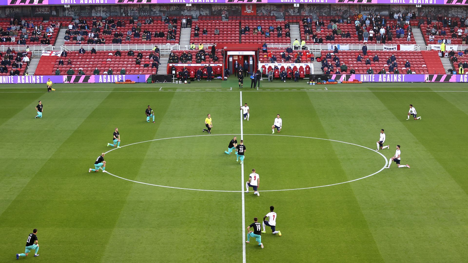 Players and officials take a knee in support of the black lives matter movement during the international friendly match between England and Austria at Riverside Stadium on June 02