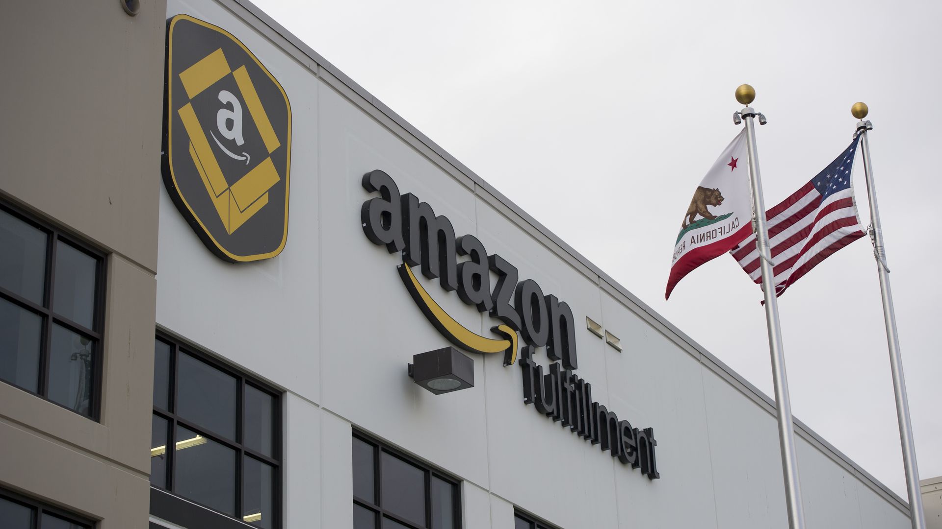 exterior of an Amazon fulfillment center with logo and sign of company