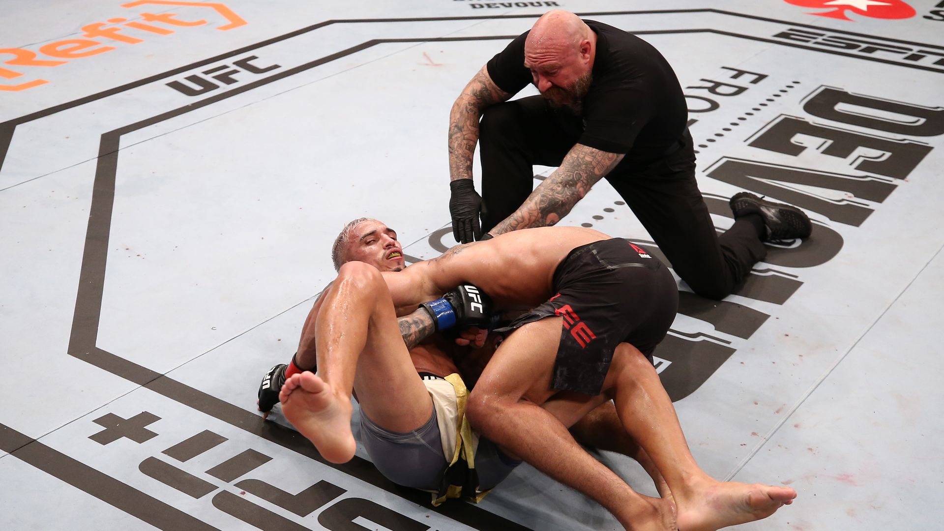 Charles Oliveira of Brazil secures a guillotine choke submission against Kevin Lee