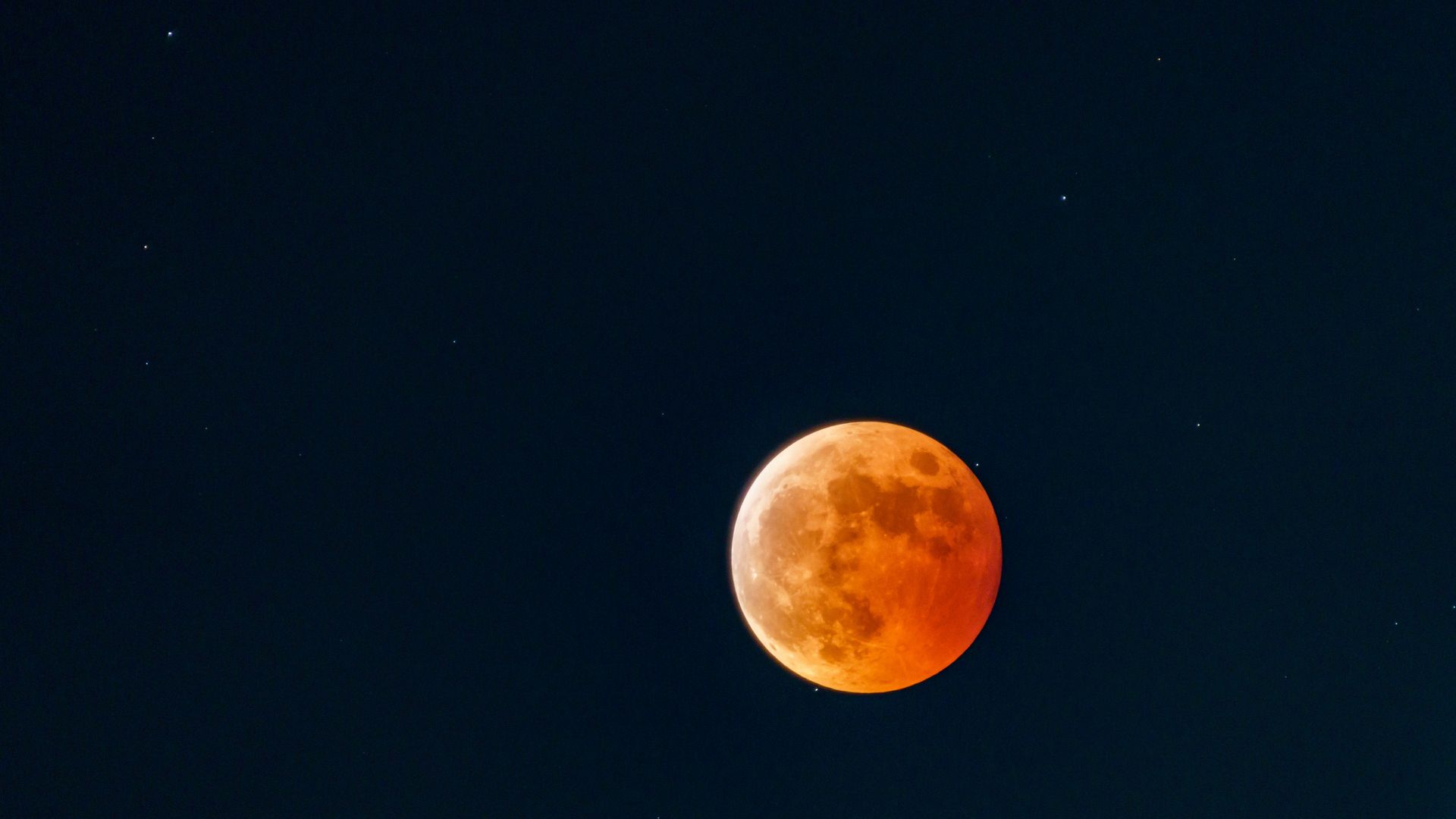 A bright orange moon during an eclipse.