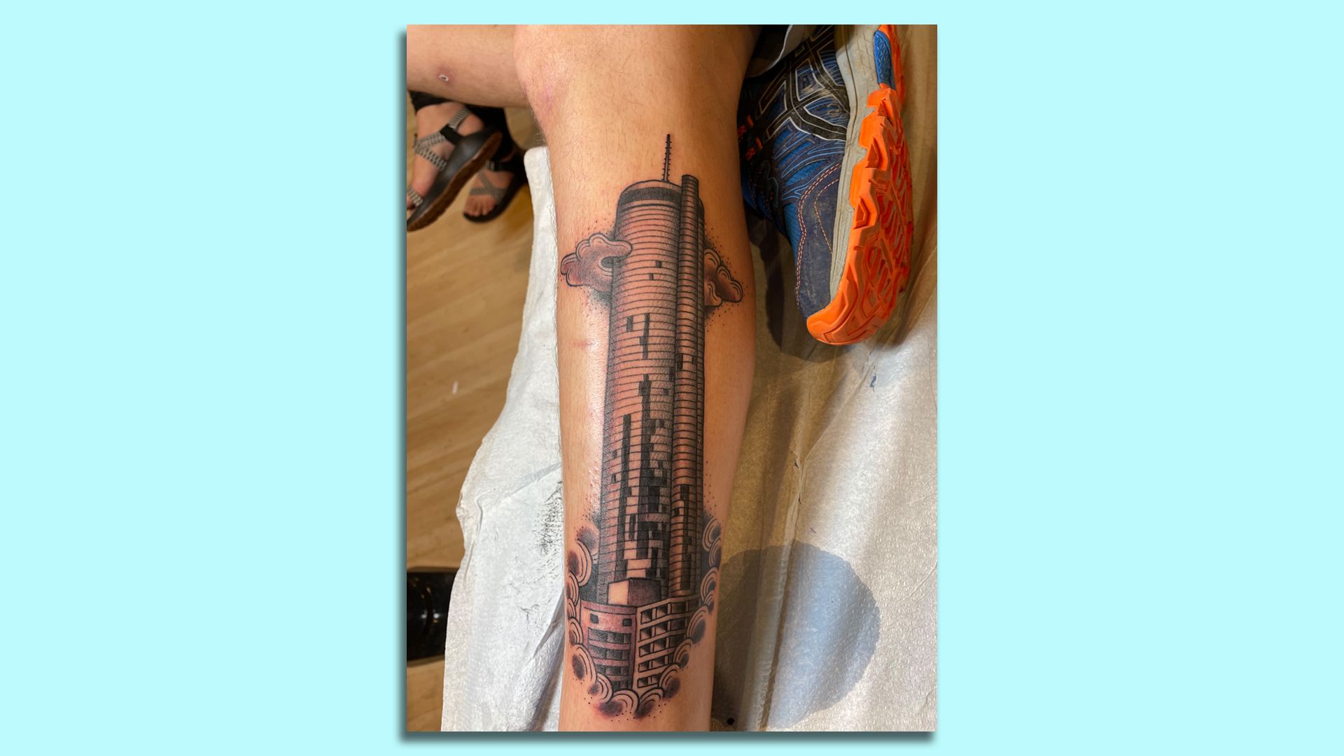 A detailed tattoo of the Westin Peachtree Plaza with windows missing after the 2008 tornado