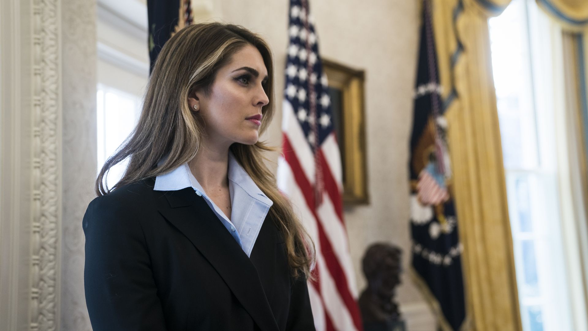 Hope Hicks next to American flag.