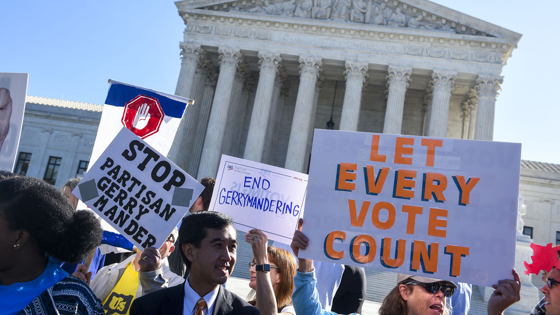 Protesters wave anti-gerrymandering signs outside the Supreme Court building