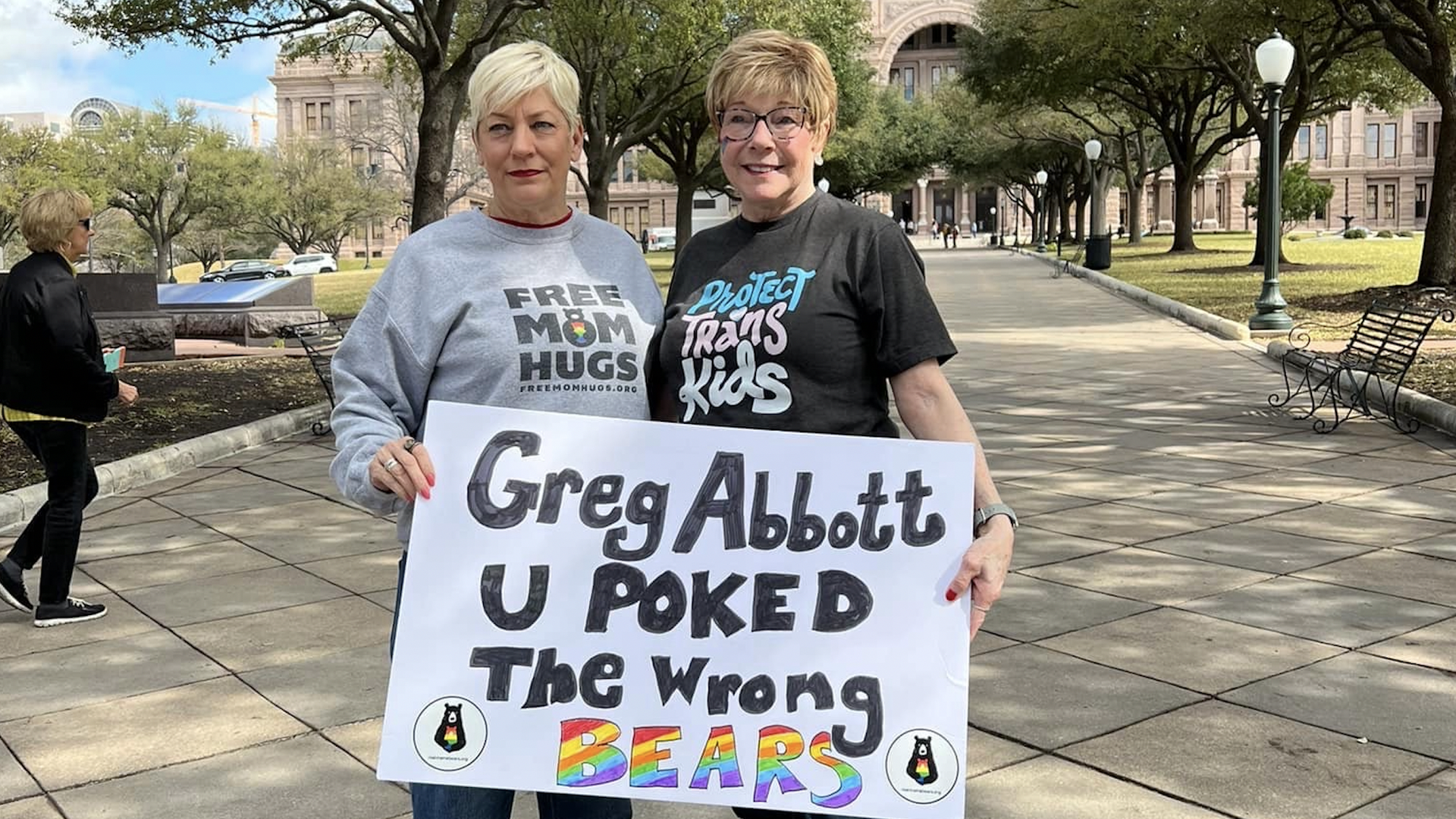 A photo of two women holding a sign 