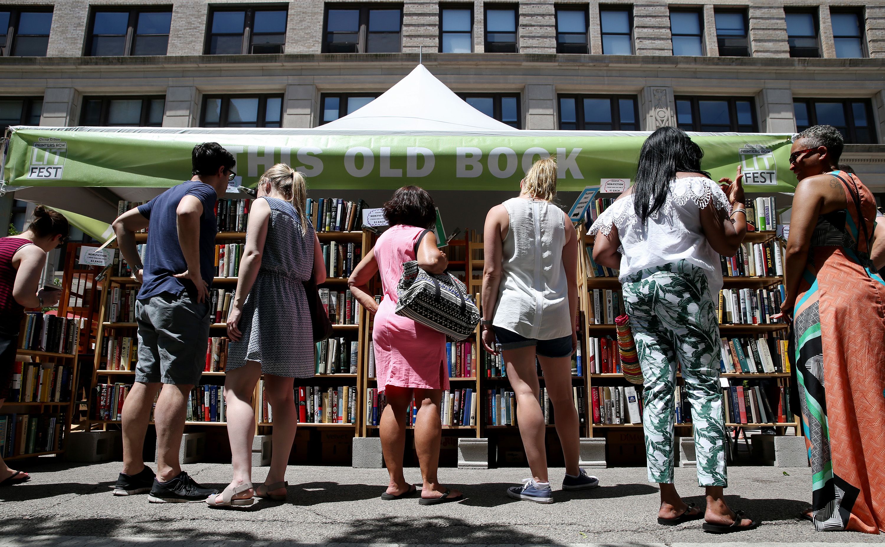 Photo of people browsing at a tent during a street festival 