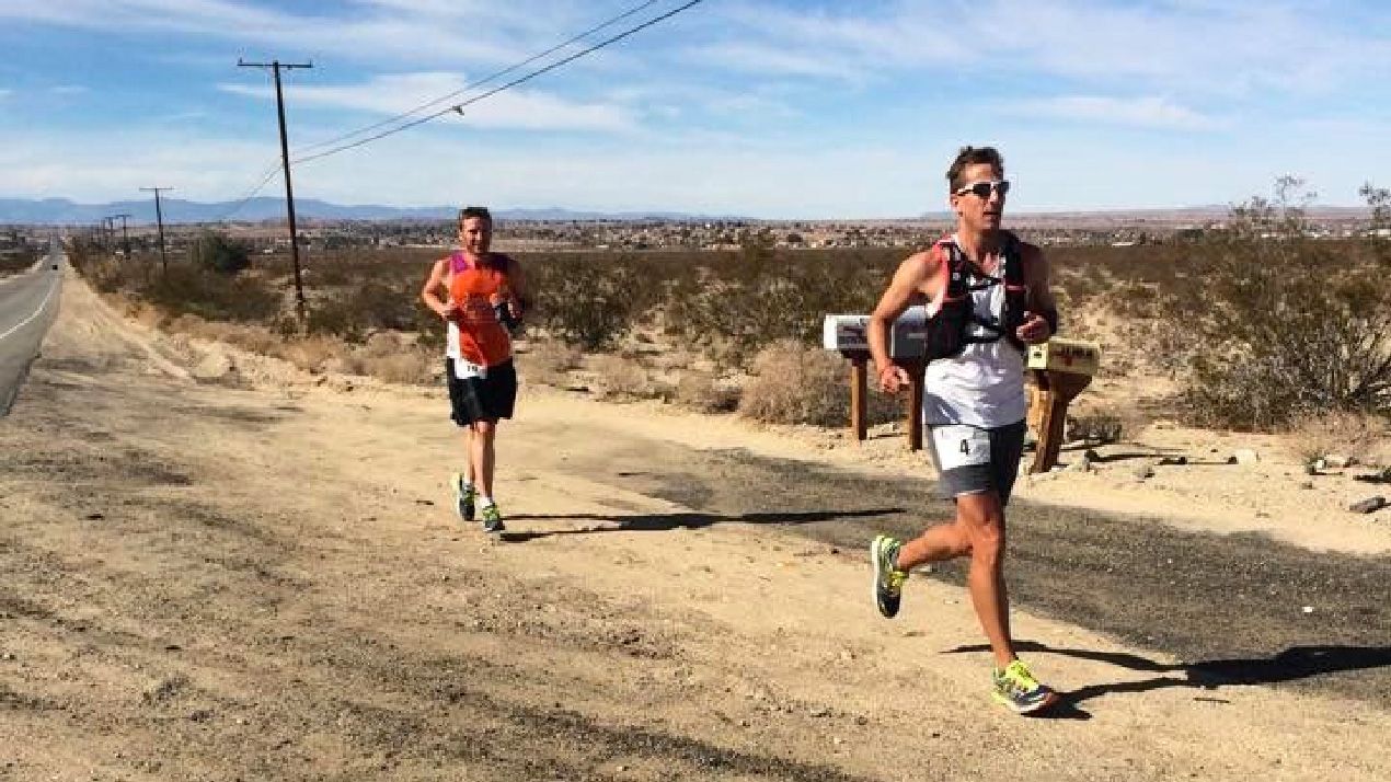 Photo of two RAUSA ultra athletes running in a desert