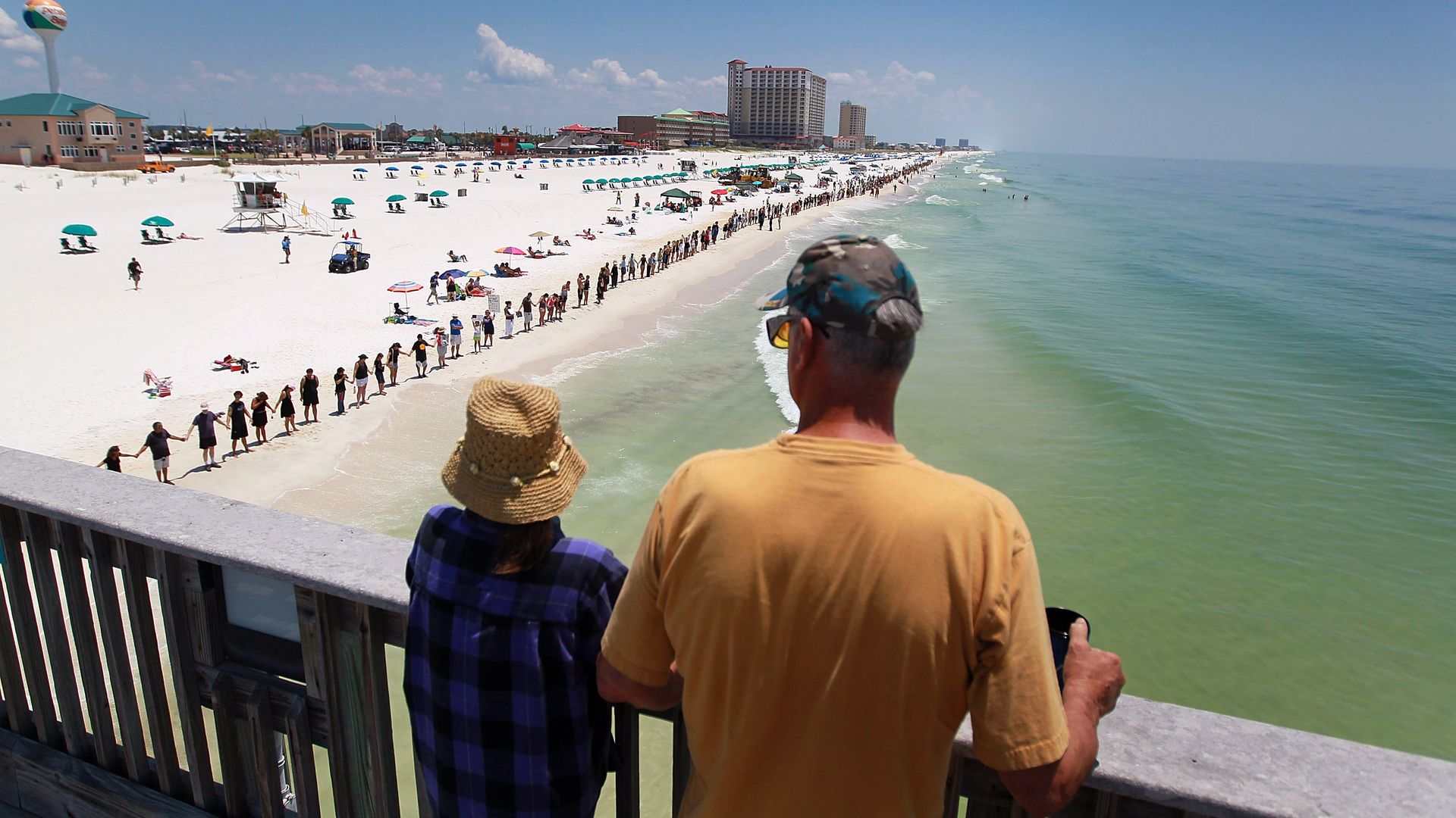 Line of people stretches across Pensacola beach in the June 2010 Hands Across the Sand protest against the Deepwater Horizon oil spill