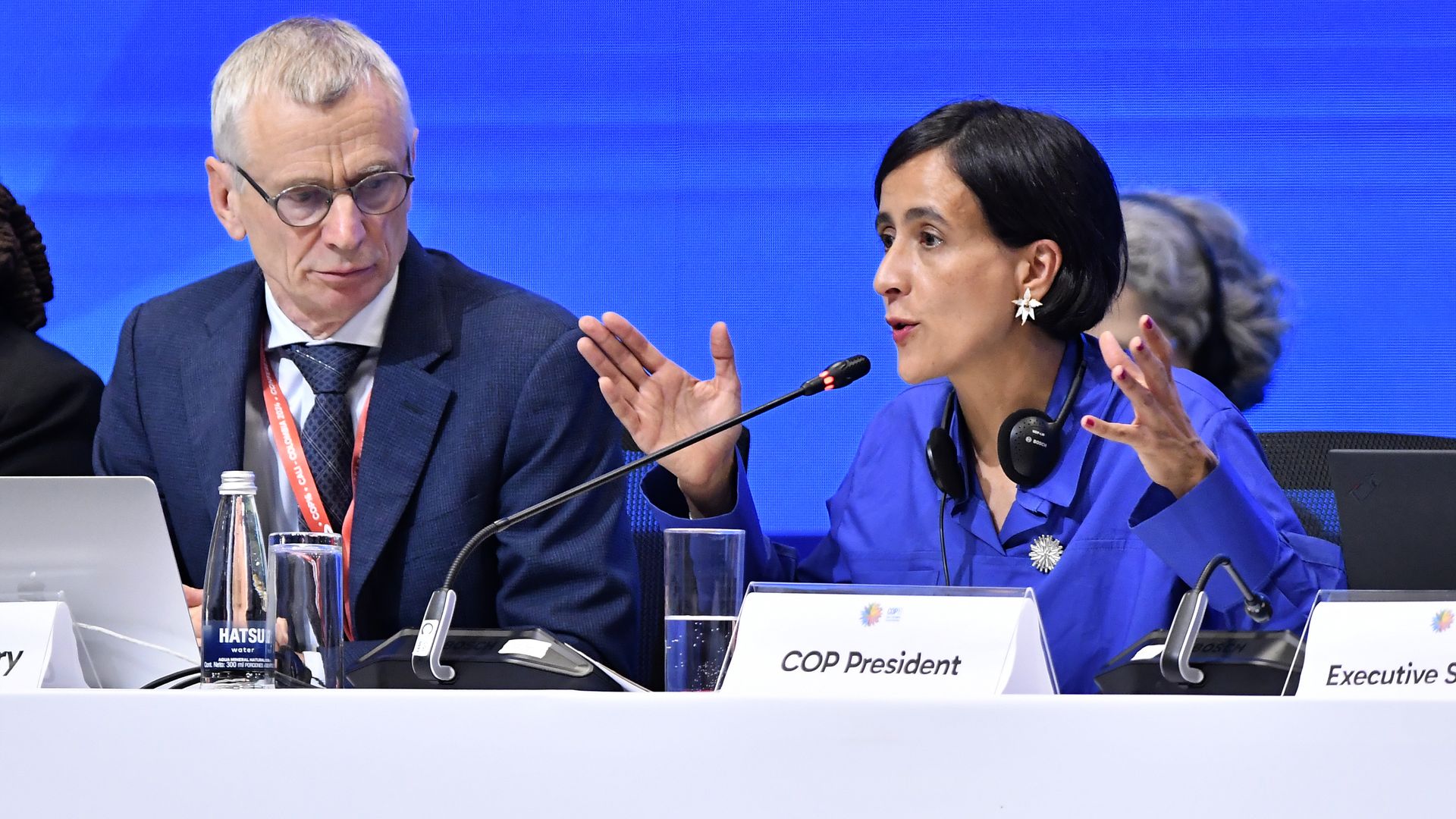 A woman is talking while a man looks on at a UN summit on biodiversity in Colombia.