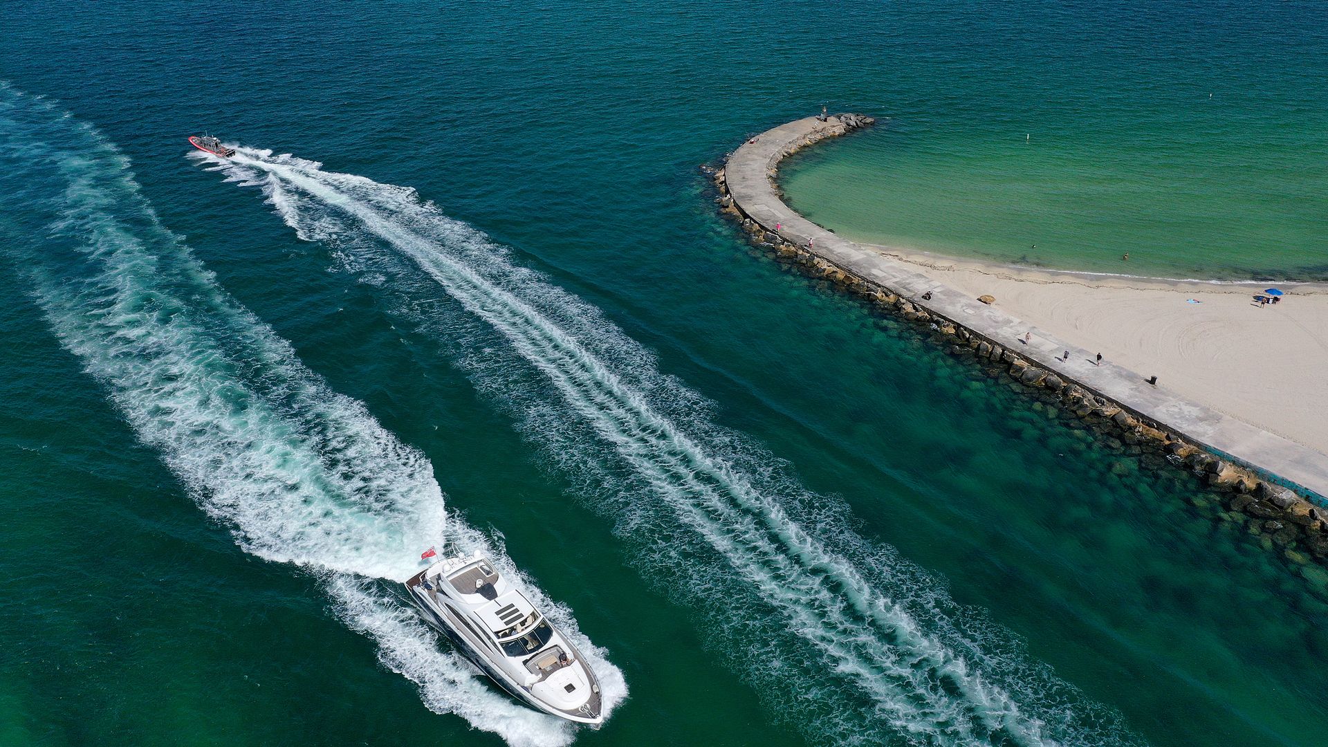 Boats cut through a channel in Miami 