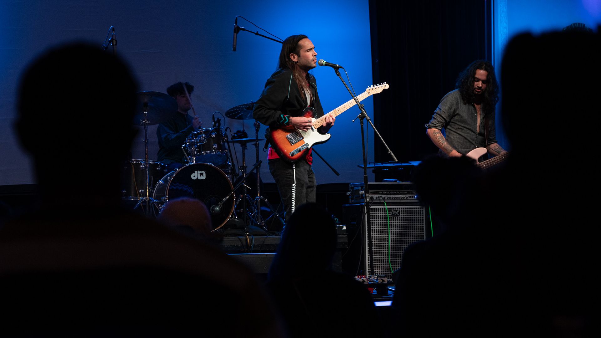 Native musician "OPLIAM" performing on stage.