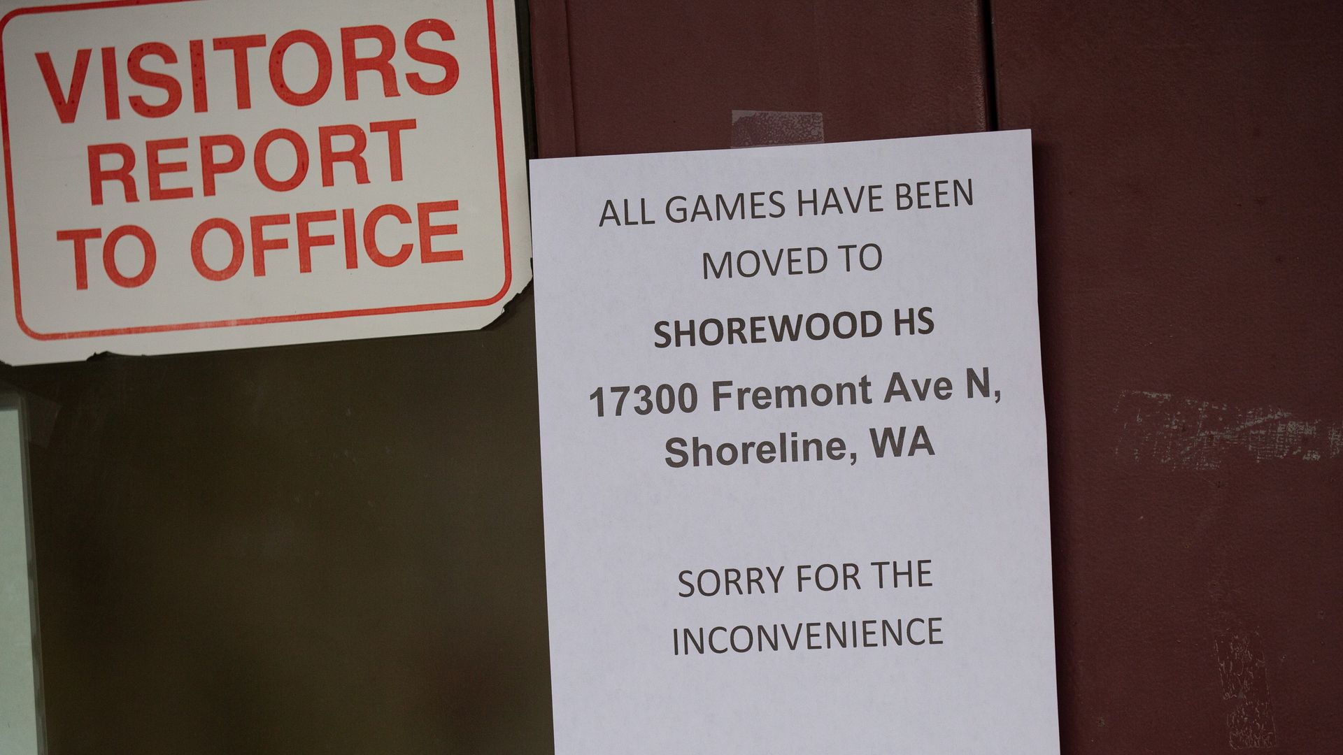A sign on a door of Jackson High School saying all sports events have been moved to a different school