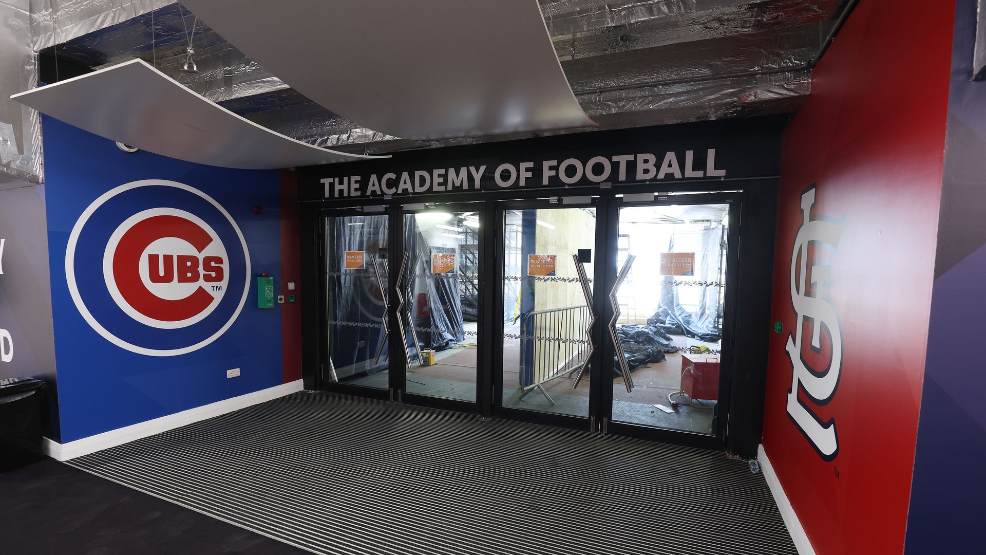 Photo of two big baseball logos near doors 