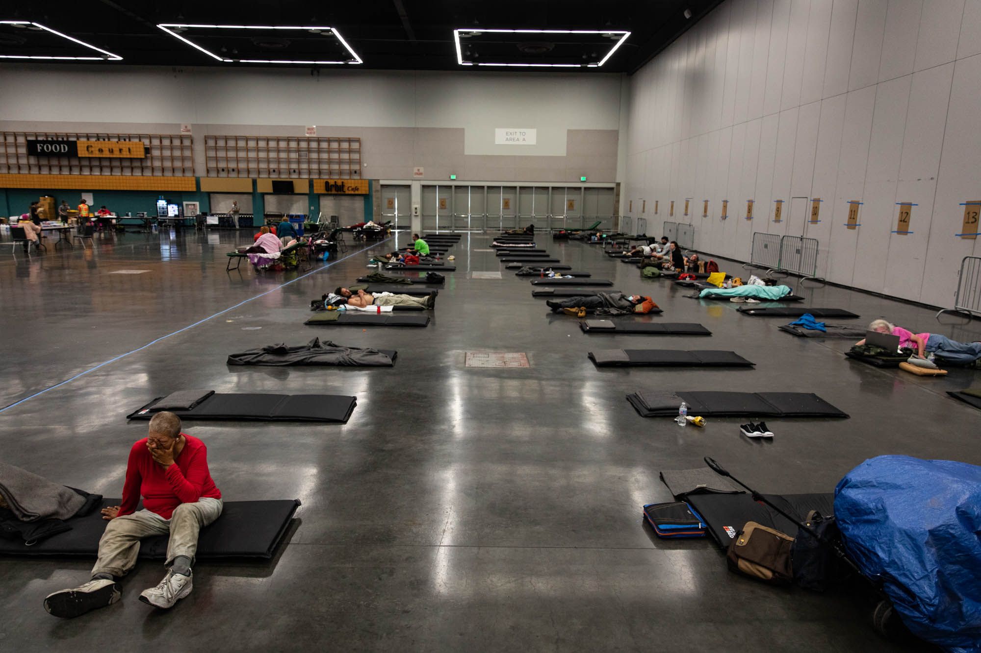Residents gather in a public cooling shelter set up at the Oregon Convention Center 