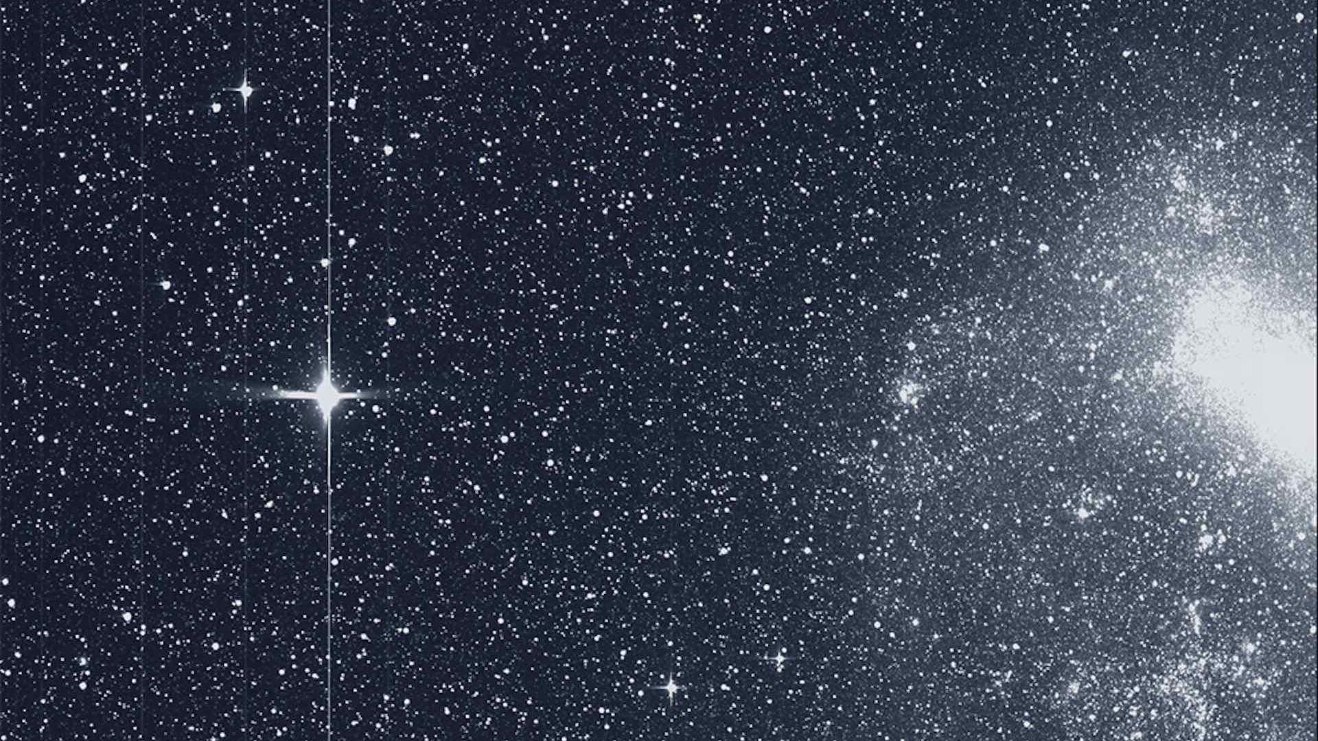 A photo of a star and the Large Magellanic Cloud taken by TESS.