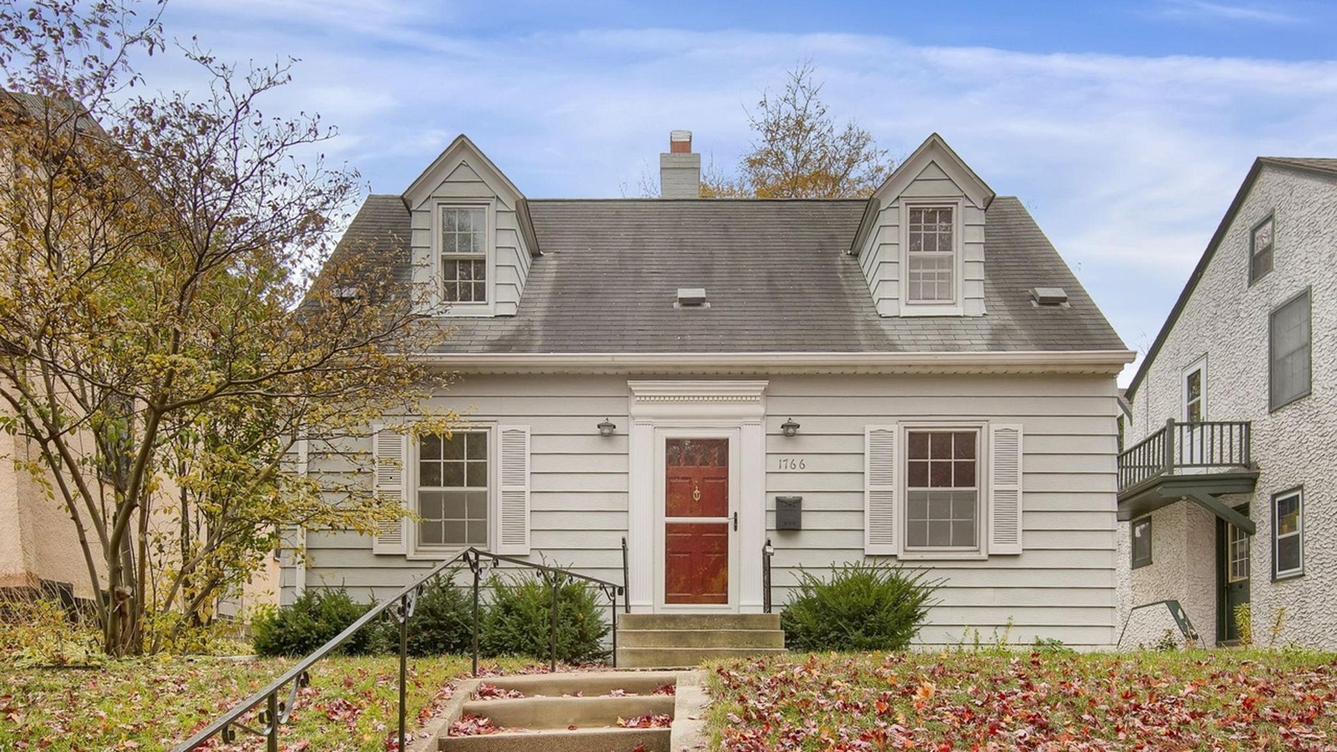 outside of cream home with red door