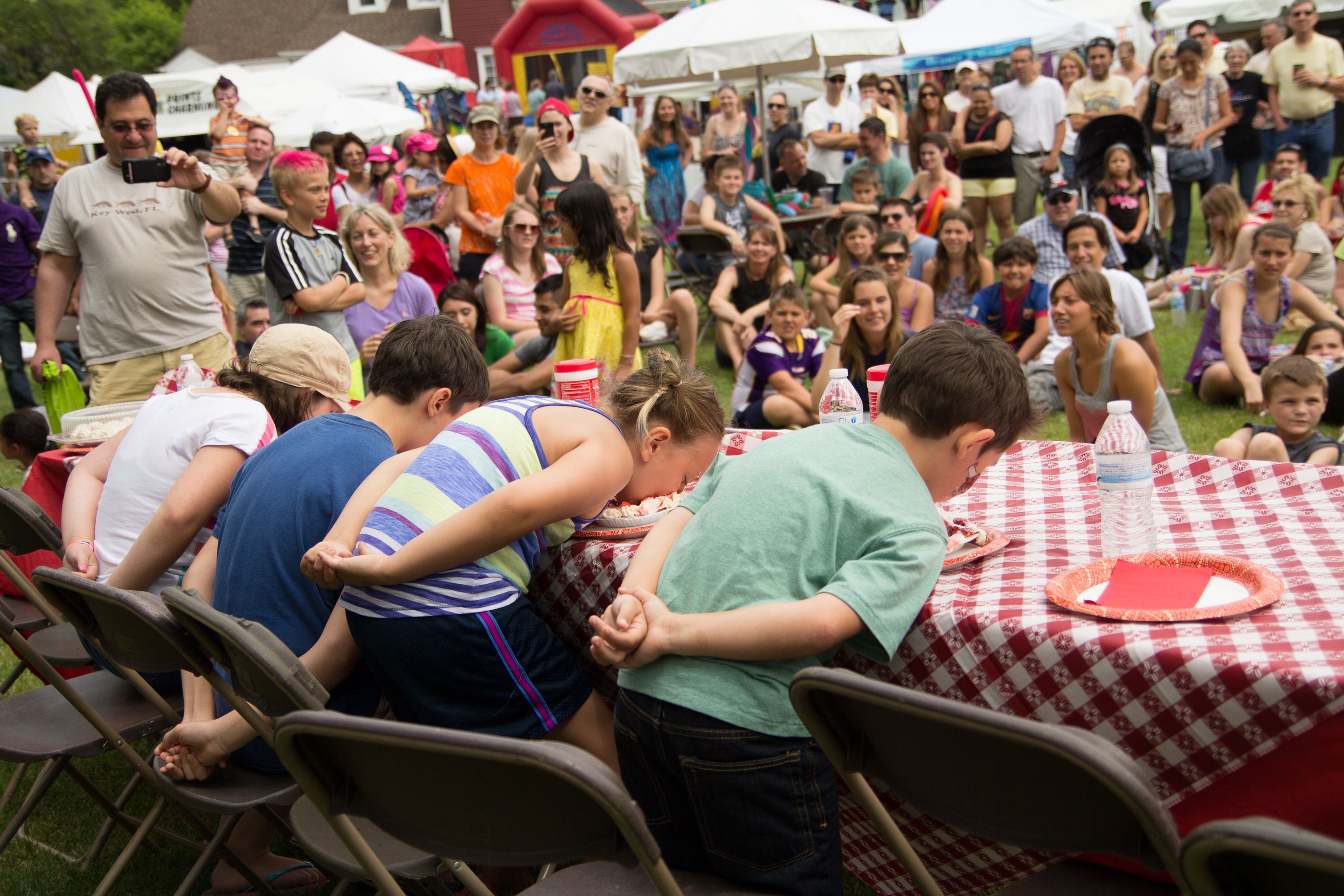 Photo of kids eating strawberry pie in a contest 