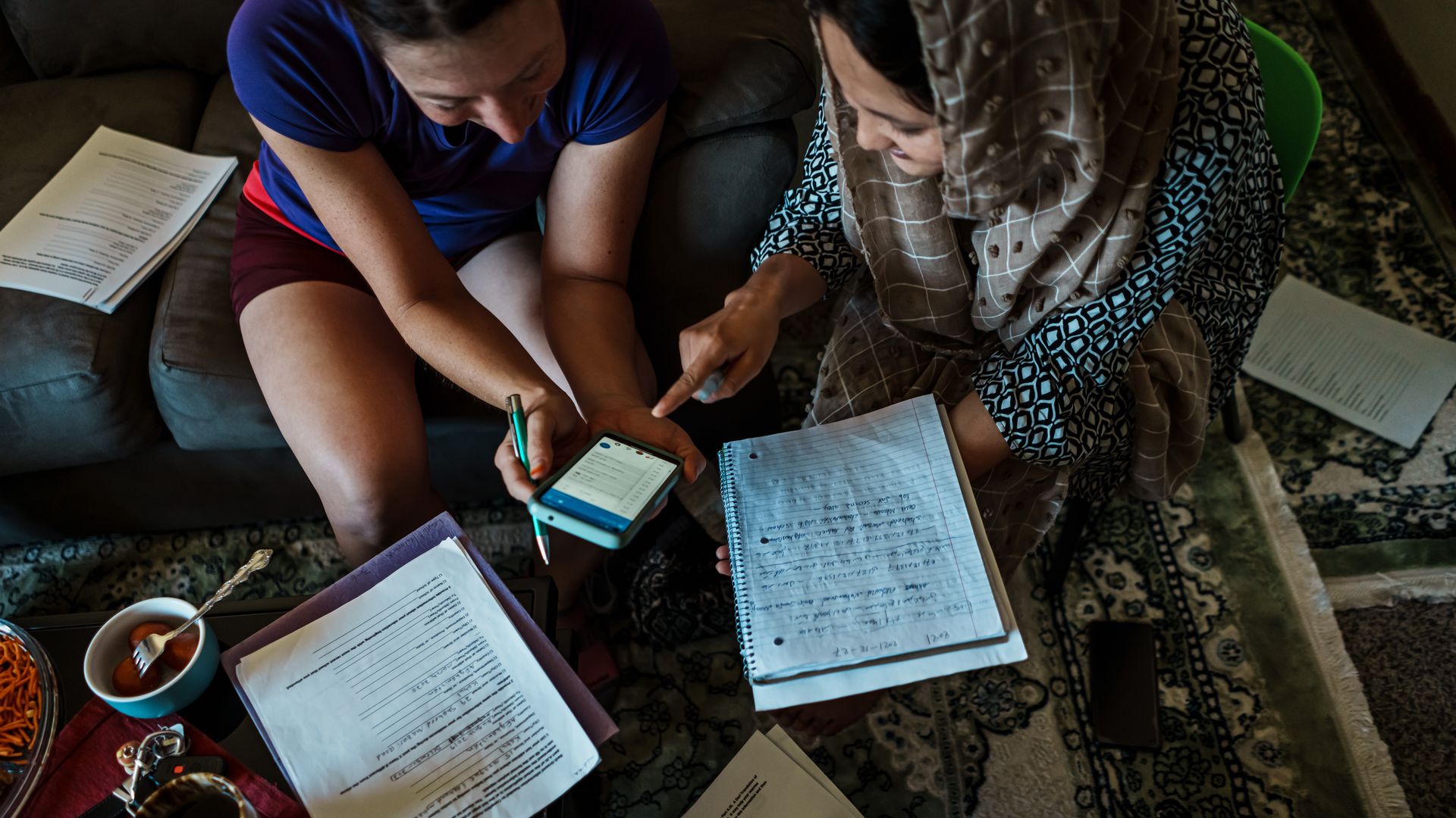 A photo of a woman filling out asylum paperwork.