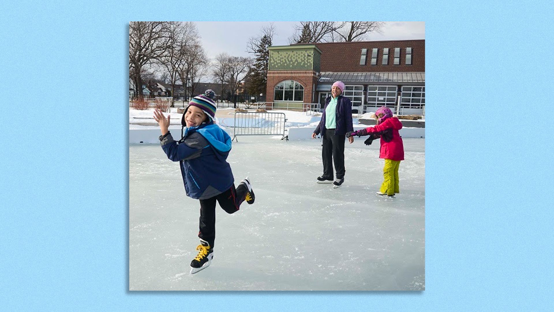 a boy skating on an ice rink happily