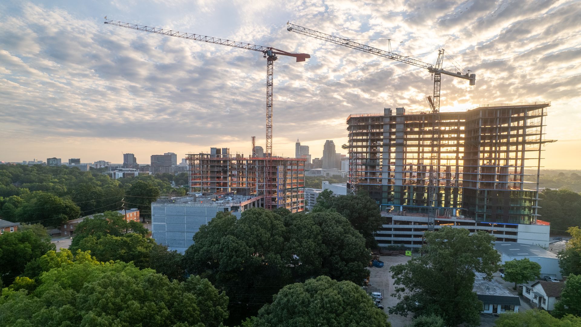 An under-construction apartment tower with Raleigh's skyline in the background