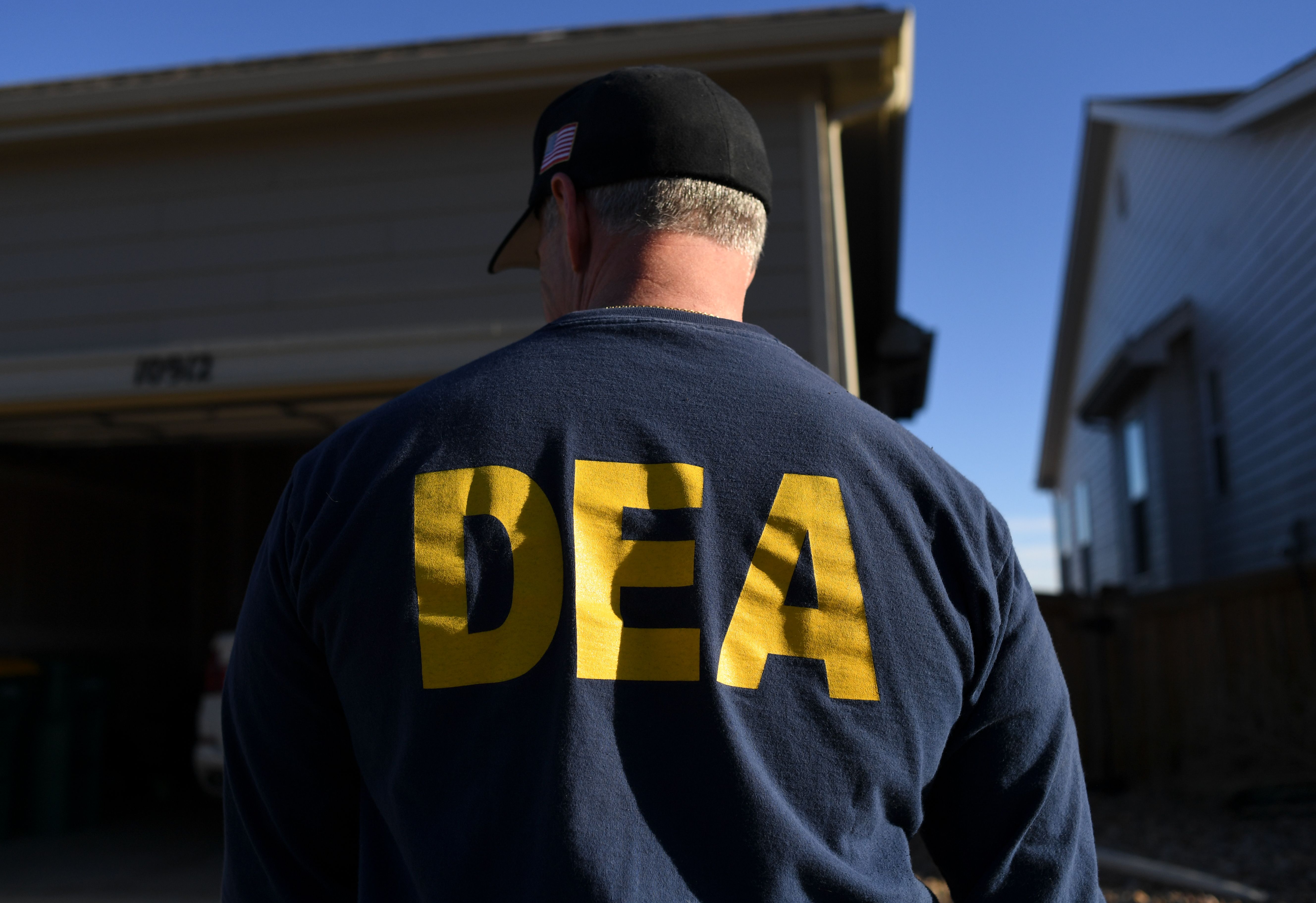 DEA agents conduct a raid at two side-by-side homes in Commerce City, Colorado, as part of an investigation into an alleged illegal marijuana operation