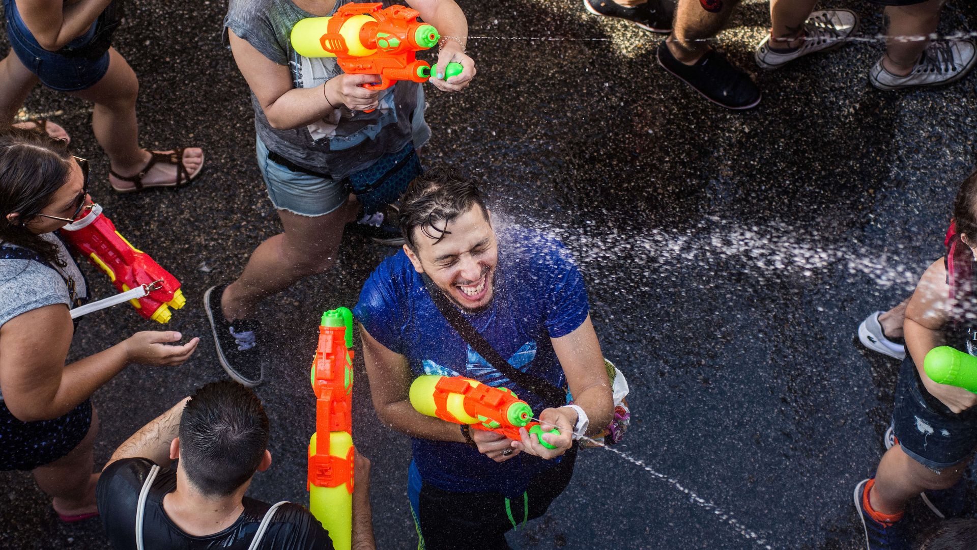 Photo of people squirting water guns