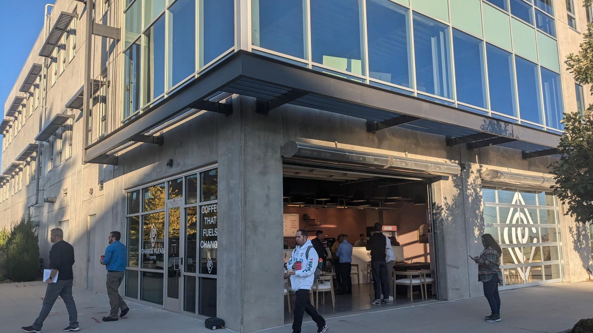 coffee shop on city corner with open garage door style window