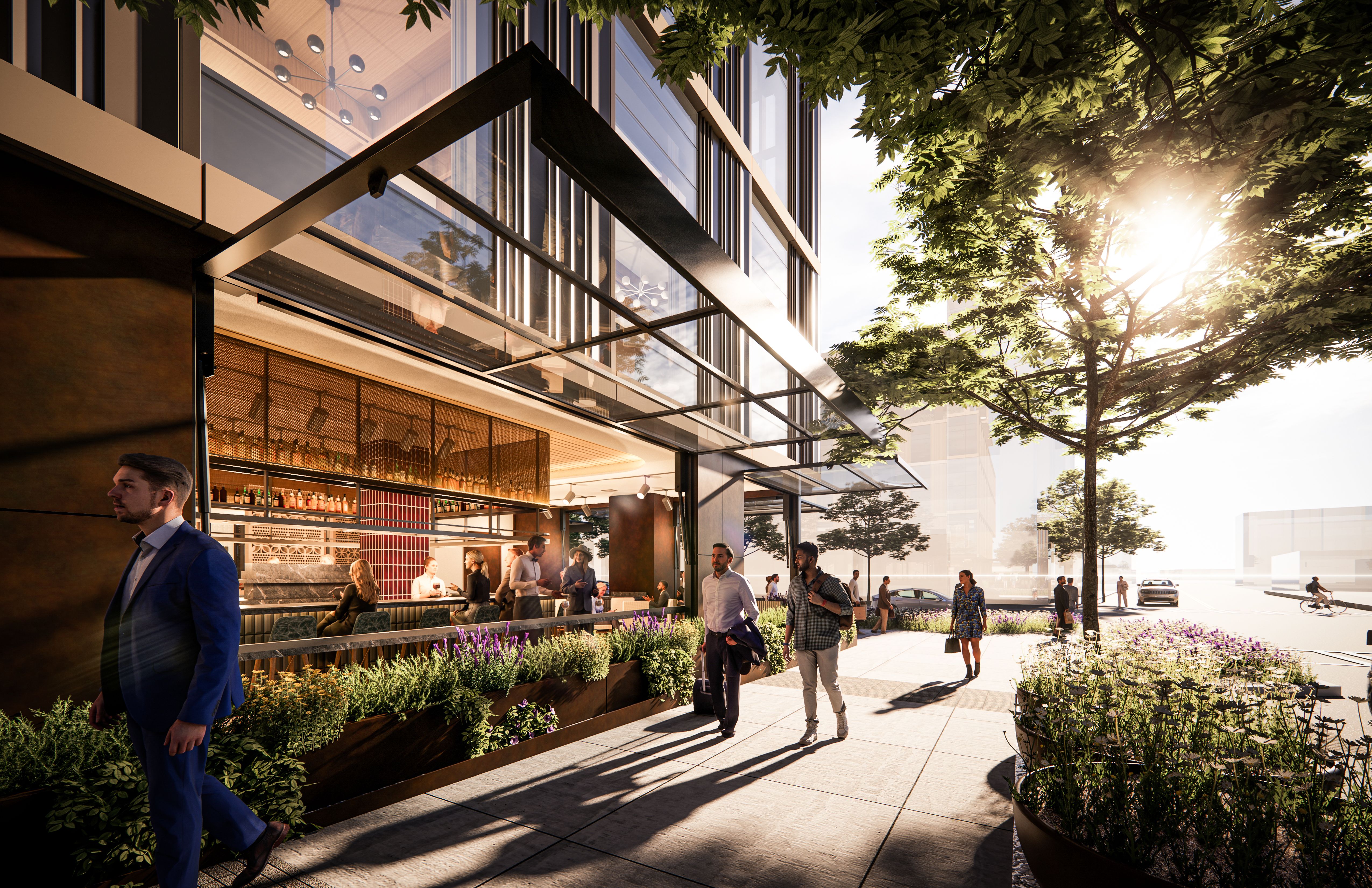 Modern glass-fronted building with an outdoor cafe along a planter-filled terrace. People mingle, metal framing and large windows reflect sunlight as trees shade the scene.