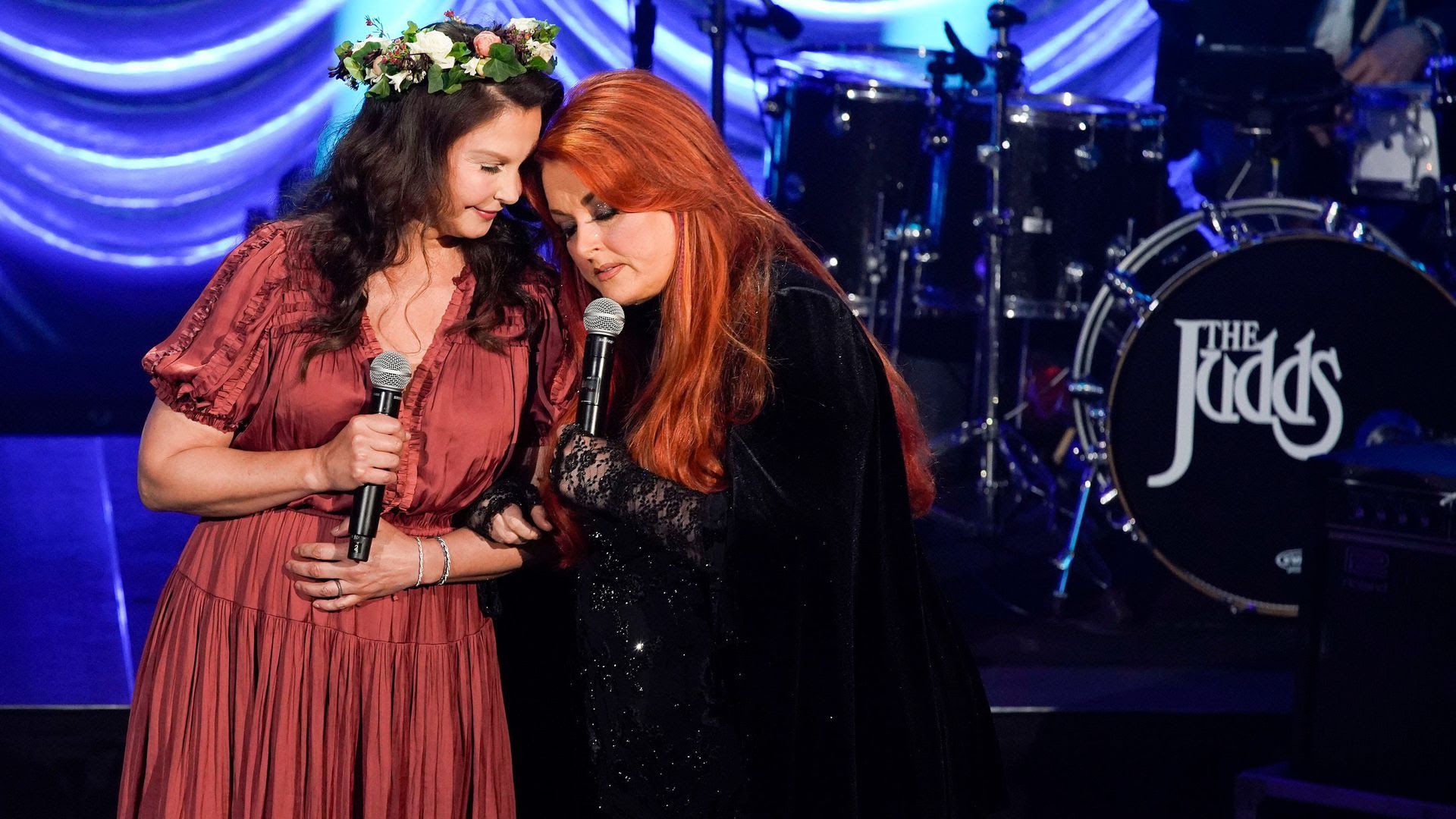 Ashley and Wynonna Judd hug on stage