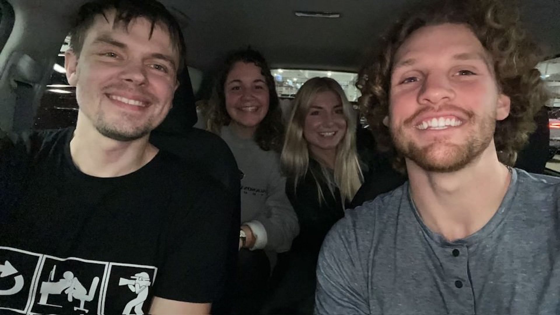 a selfie of 4 people in a car