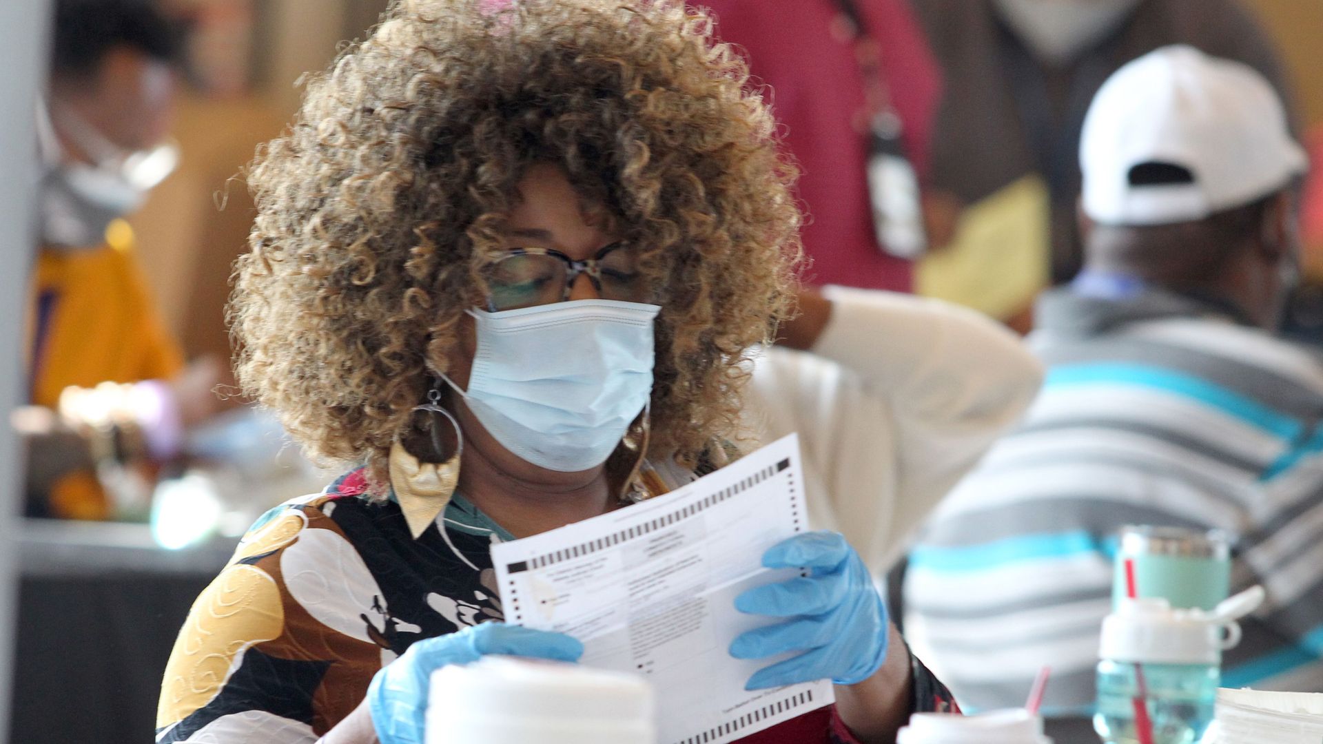 Fulton County, Ga., elections worker inspects ballots cast in the Nov. 3 presidential election.
