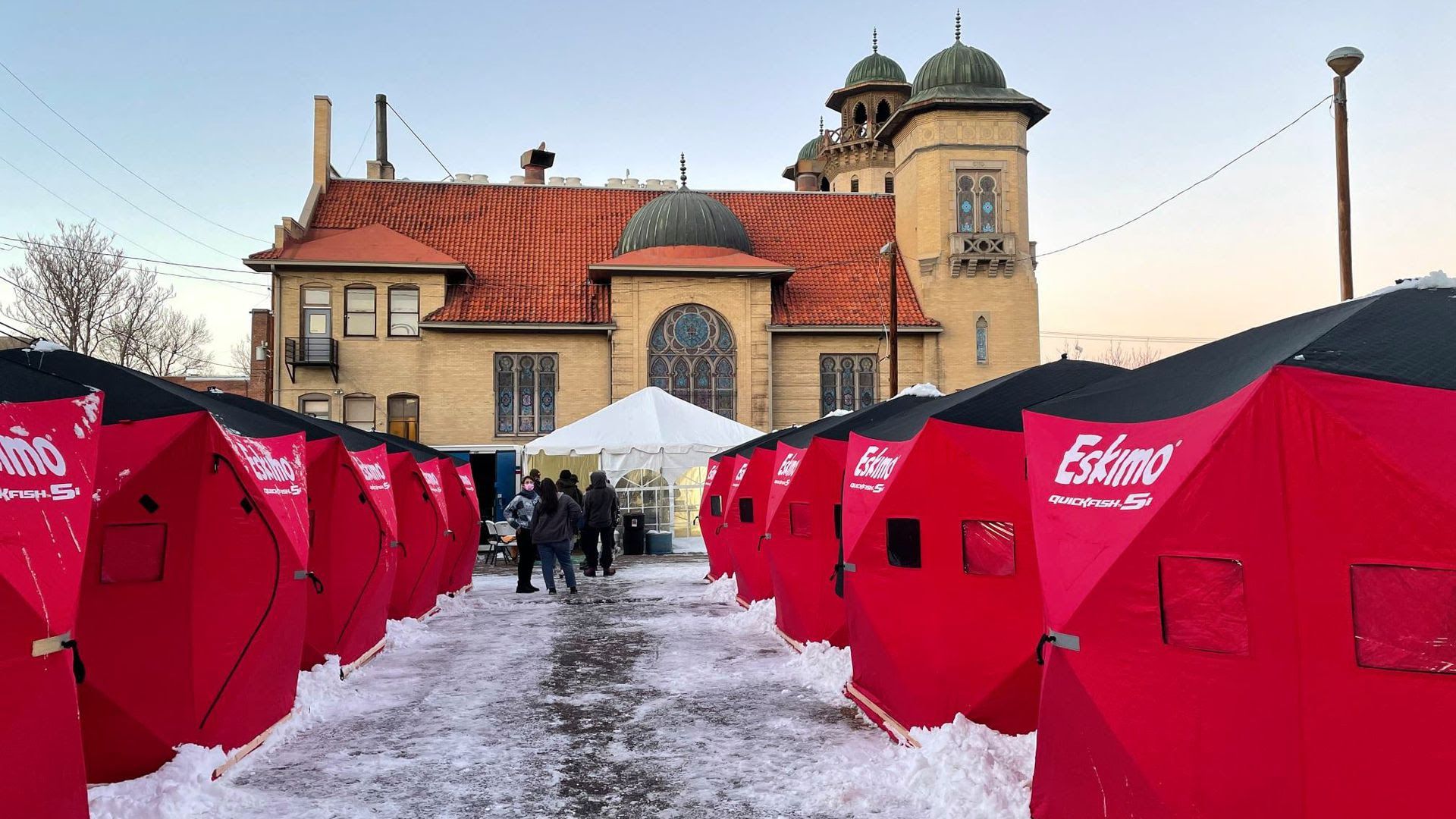 A "Safe Outdoor Space" with red tents for the homeless in the parking lot of the Denver Community Church at 16th and Pearl streets.