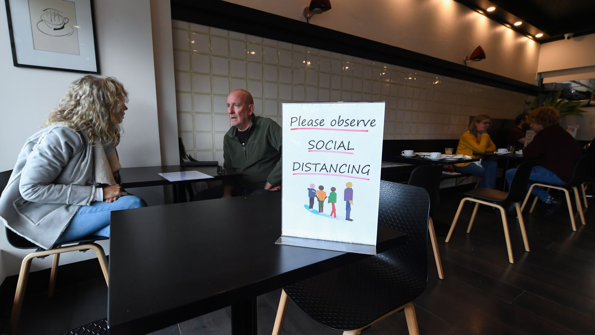 People enjoying some food and coffee inside a cafe